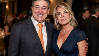 Itzhak Ezratti and his wife posing together at a formal event